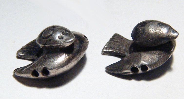 Pair of detailed Inca silver birds: A pair of detailed Inca silver birds, Peru, c. AD 1300 - 1500, hollow-formed and wonderfully hand crafted with incised eyes and tail feathers, double horizontal suspension holes through the forepart o