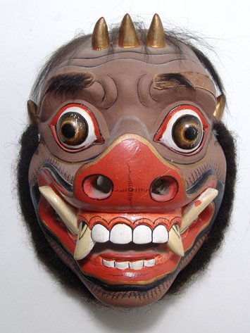 Barong' mask of a demon: A nice 'Barong' mask of a demon with a boar’s visage, Bali, Indonesia, mid-20th Century, one of the Rangdas evil and numerous retinue, of polychromed wood with added 'hair' decoration. H: 8 in (20 c