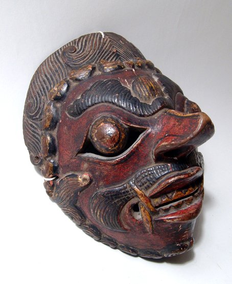 An Indonesian Topeng Mask Depicting Klono the Evil King: An Indonesian Topeng mask, early-mid 20th Century, depicting 'Klono', the evil King, of polychromed wood. L: 8 in (30 cm). A nice example which appears to have seen some use. Ex Silver collection.