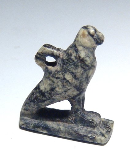 Egyptian speckled serpentine amulet of a falcon: A nice Egyptian speckled serpentine amulet of a falcon, Late Period, c. 664 - 30 BC, carved in the round on integral rectangular base, suspension loop at back. 2.3 x 1.8 cm. Intact. Ex Los Angeles pri