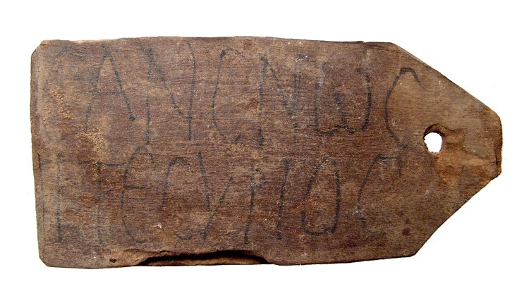 Egyptian wood ‘mummy tag’ with Greek name: An Egyptian wood ‘mummy tag’ with Greek name, c. 1st - 2nd Century AD, of typical form with tapered end holed for suspension, written in black pigment is CANCNWC ΠECVPIOC (Sansnos Pecurius), 