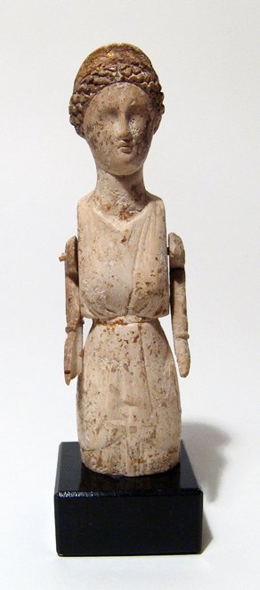 A choice Roman bone doll of Venus: A choice Roman bone doll of Venus, c. 2nd - 3rd Century AD, her features well-carved with hair curled into a bun at the nape of her neck behind a tall stephane which retains much of the original gildi