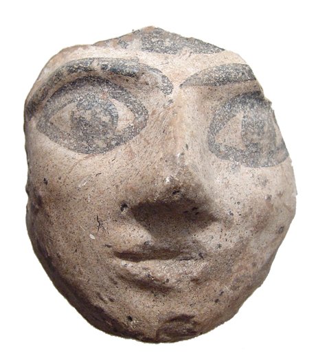 Egyptian painted stucco face from a statue: An Egyptian painted stucco face from a statue, Late Period, c. 664 - 30 BC, with large almond-shaped eyes and angular nose. Antique wood attachment on back where it was once mounted to something else.