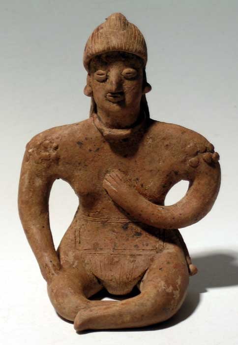 A fine Colima figure from West Mexico: A fine Colima figure from West Mexico, ca. 300 BC – 300 AD. It is 4 ¾ in high and depicts a seated male with legs crossed and one hand held to the chest. He is wearing a loin cloth with sash and a