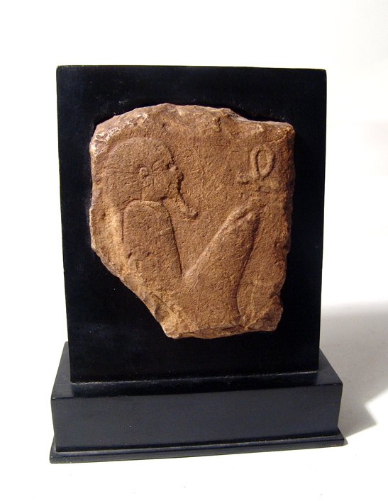Egyptian relief fragment depicting Ma’at: An Egyptian limestone raised relief fragment depicting Ma’at, Late Period, c. 664 - 343 BC, the goddess is depicted seated with feather atop her head, her bended knee surmounted by an ankh. H: 3 1/3