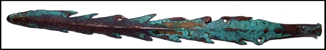 A bronze serrated spearhead, Central Asia: A bronze serrated spearhead, Central Asia, c.3rd Millennium BC, An interesting weapon with long barbed spines along the length, leafed shaped blade at the tip. The base with a pair of hold for attachm