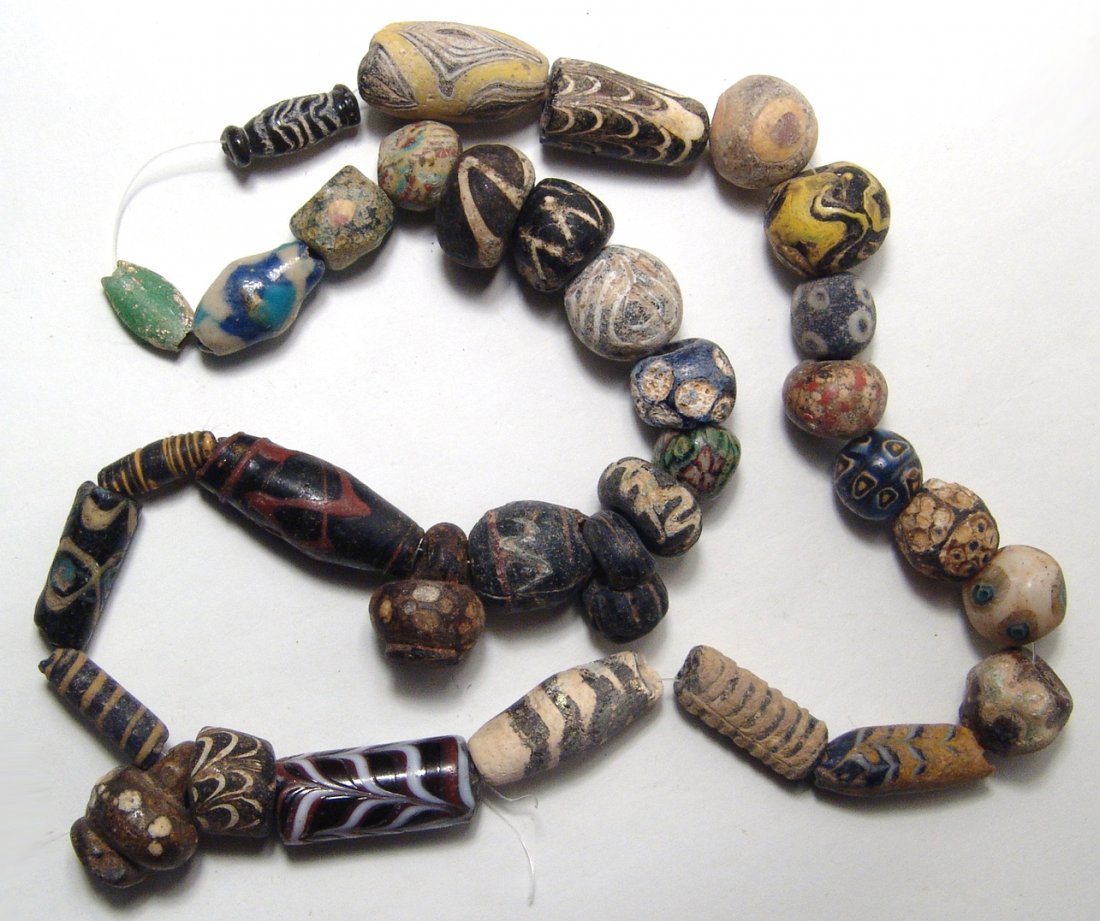 An attractive strand of mixed ancient beads: An attractive strand of mixed Roman, Byzantine and Islamic glass beads, of various sizes and colors, most quite beautiful and makes for a very nice group! Largest bead measures 3.2 cm in length. Ex Lo
