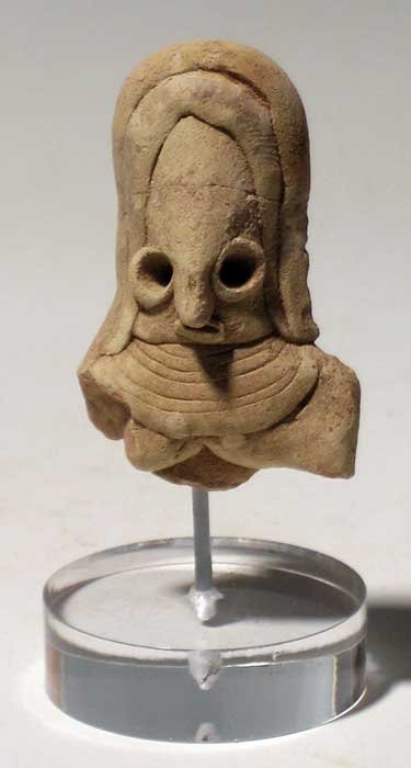 An exquisite Mehrgarh female bust: An exquisite Mehrgarh female bust, c. 3500 – 2000 BC. It is 2 in high and depicts a young female with a complex headdress. She is wearing a broad collar or chest piece just touching her breasts. Goo
