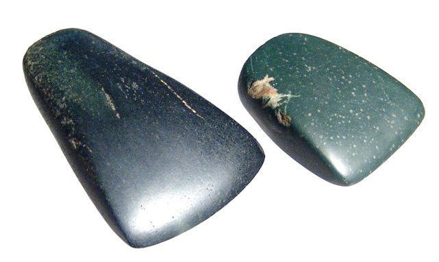 A pair of Mayan stone celts, Guatemala: A pair of Mayan stone celts, Guatemala, c. AD 400 - 700, both well-preserved with a good polish, the smaller in a deep green nephrite, the other almost black with streaks of green. L: 1 ½ in (2.8 cm)