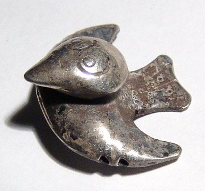 An attractive Inca silver bird, Peru: An attractive Inca silver bird, Peru, c. AD 1300 - 1500, hollow-formed and wonderfully hand crafted with detailed head and double horizontal suspension holes through the forepart of the wings. 2.4 x 2
