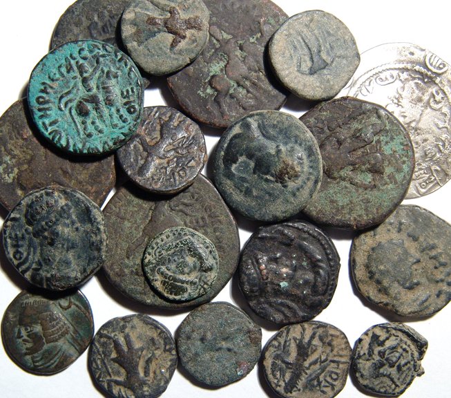 A lot of 20 ancient silver and bronze coins: A lot of 20 ancient silver and bronze coins. Lot includes a variety of Kushan bronzes from the 1st - 2nd Century AD, a Parthian drachm as well as a large Hunnic silver coin from Central Asia. Largest 