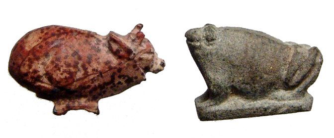 A pair of well detailed stone amulets: A pair of well detailed stone amulets, Late Period, c. 664 - 30 BC. Lot includes a a trussed ox amulet in speckled rhyolite, L: 25mm, and a grey rhyolite from, L: 21m. Both extremely well detailed and