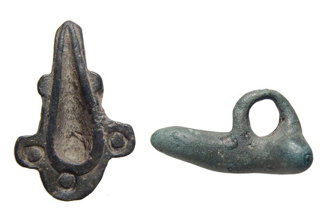 A Roman palm thimble and phallic ornament: A Roman palm thimble and phallic ornament, c. 1st - 3rd Century AD, the thimble with central tear-dropped shaped recessed area and decorated on both sides with incised circles, 7.8 x 2.6 cm, the phall