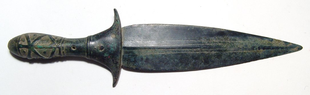 A lovely Elamite bronze dagger: A lovely Elamite bronze dagger, c. mid-3rd Millennium BC, with short leaf-shaped blade made separately from the hilt, two parallel blood channels to either side of the midrib on both faces. The hilt w