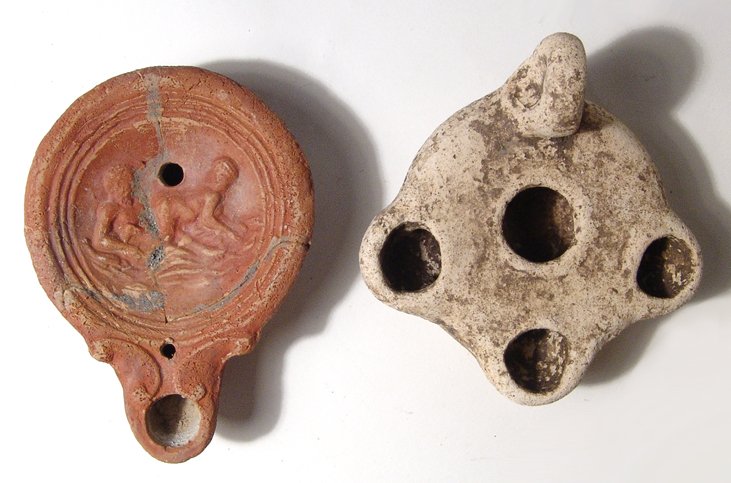 A pair of attractive Roman lamps: A pair of attractive Roman lamps. Lot includes a red-ware erotic type, 1st Century AD, featuring a river-god engaged in sex with a nymph. L: 3 7/8 in (9.8 cm). Repaired. The second lamp is triple-spou