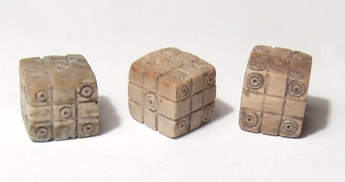 A lot of 3 Roman bone dice: A lot of 3 Roman bone dice, c. 1st - 4th Century AD, a matched group numbered 1 through 6 and with the unusual addition of gridded faces with each side having nice squares for easier placement of the 