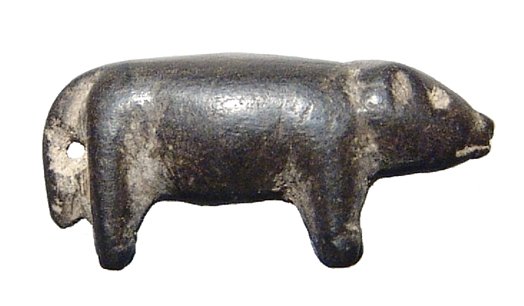 A carved black steatite amulet of a boar: A carved black steatite amulet of a boar, Northern Syria, c. 1st Millennium BC, nicely worked with naturalistic style and suspension hole between tail and back legs. L: 2.4 cm. Intact. Ex Los Angeles 