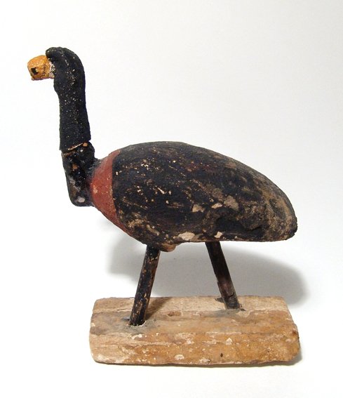 Egyptian painted wood ibis: An Egyptian painted wood ibis, Late Period, c. 664 - 30 BC, simplistically carved and still attached to the original rectangular base, with tall neck and flattened beak. Well-preserved with most of th