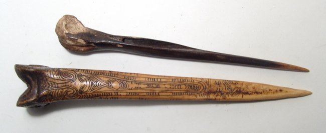 Pair of Nepalese or Southeast Asian bone daggers: A pair of Nepalese or Southeast Asian bone daggers, early-mid 20th Century, the larger nicely carved with ornate geometric decoration and both with attractive age patina. L: 11 ½ in (29.2 cm) & 25.5 