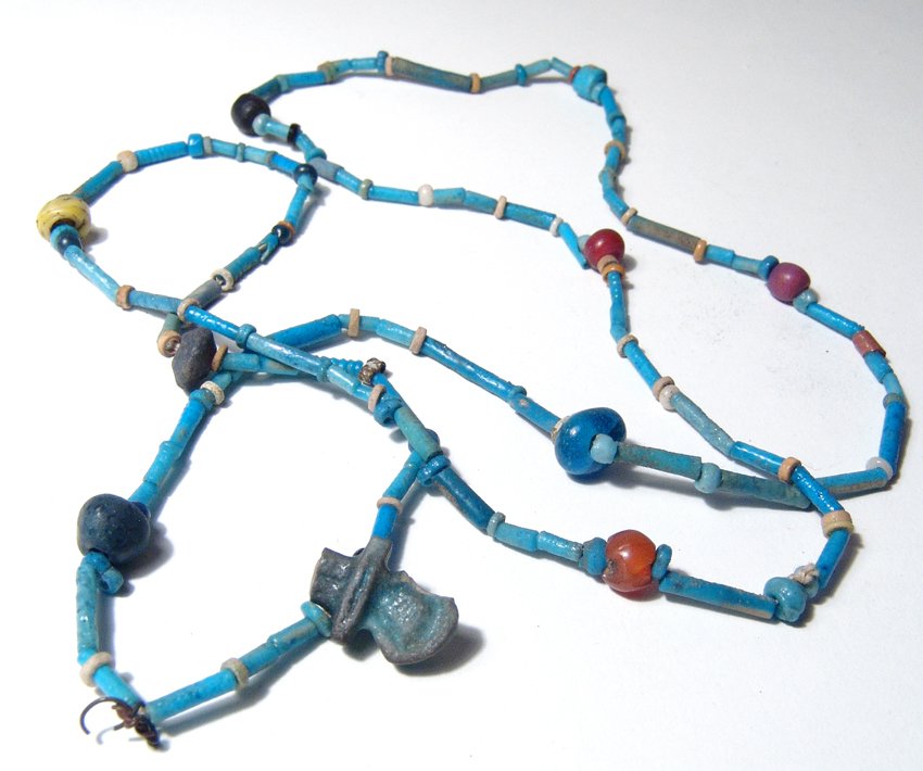 Egyptian faience and stone bead necklace, Late Period: An attractive Egyptian faience and stone bead necklace, Late Period, c. 664 - 30 BC, the brilliant blue tubular beads accented with disc beads and Roman glass and stone beads as well as an Egyptian fa