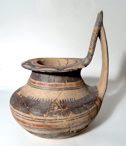 A large Daunian oinochoe, South Italy: A large Daunian oinochoe, South Italy, Late 6th - 5th Century BC, with tall, wide handle with curved top, the body rounded with flattened base, and the rim wide and flattened. The entire vessel is nic