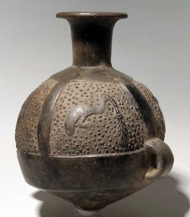 An excellent Inca arybalo from Peru: An excellent Inca arybalo from Peru, ca. 1300 - 1500 AD. It is 7-1/4 in (18.4cm) high and is decorated with four panels depicting birds, two in flight and two feeding on fish. Intact, strong mineral d