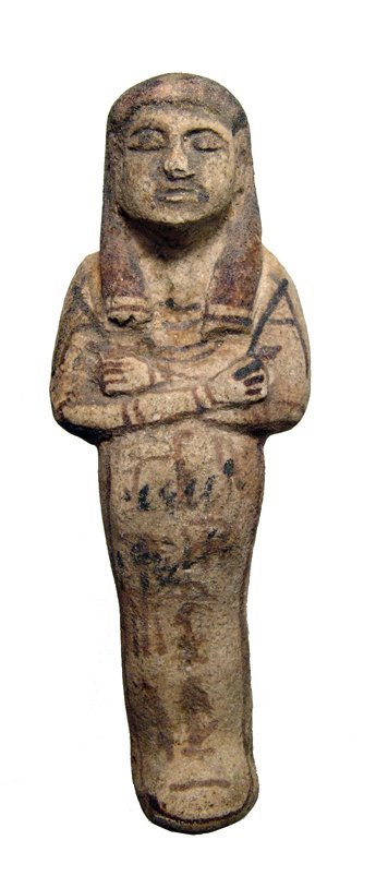 An attractive Egyptian faience ushabti: An attractive Egyptian faience ushabti, Late New Kingdom, c. 1292 - 1075 BC, depicted mummiform, wearing tripartite wig with lappets and broad collar, arms folded across chest, each hand holding a hoe