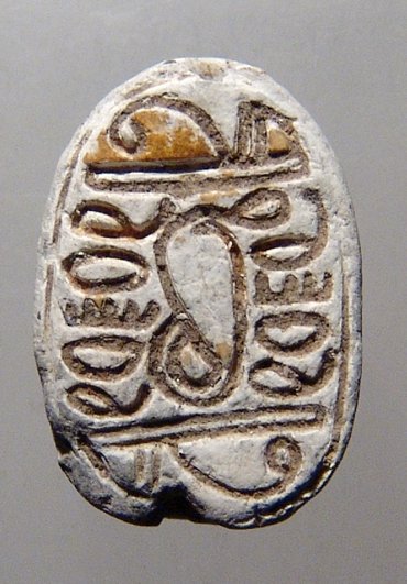 An Egyptian New Kingdom steatite scarab: An Egyptian New Kingdom steatite scarab. Uraeus engraved on base among other symbols, L: 1.6 cm, W: 1.1 cm. Collection of an Cheltenham, England Doctor From the 1950's.