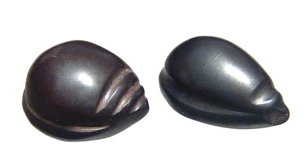 A pair of Old Babylonian hematite weights: A pair of Old Babylonian hematite weights, c. 1900 - 1750 BC, both nicely carved in the form of a shell with attractive style and good detail. L: 1.4 cm & 1.6 cm. Ex Los Angeles private collection.