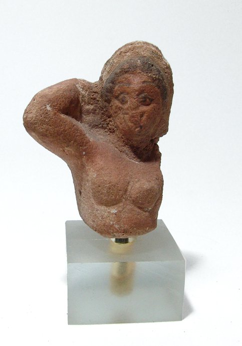 Egyptian painted composite torso of a woman: An Egyptian painted composite torso of a woman, Ptolemaic, c. 3rd - 2nd Century BC, wearing tall diadem, her curled hair in black, right arm at the side of her head. H: 2 ¾ in (7 cm). An attractive p