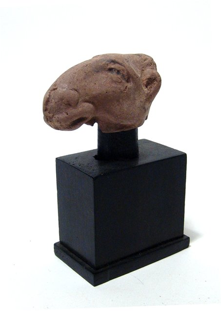 Egyptian terracotta head of a camel, Roman Period: An Egyptian terracotta head of a camel, Roman Period, c. 1st - 3rd Century AD, in naturalistic style with good detail and light deposits. Head without stand - 3 3/8 in (8.5 cm). Custom stand. Ex Phila
