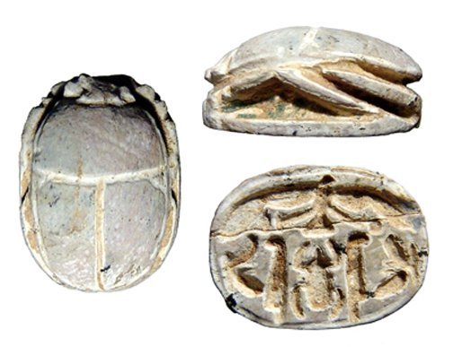 Egyptian steatite scarab, New Kingdom: A nicely carved Egyptian steatite scarab, New Kingdom, c. 1570 - 1075 BC, the body well formed, on base, a center Kheper sign flanked by feathers and standing winged goddesses, above a winged vulture.