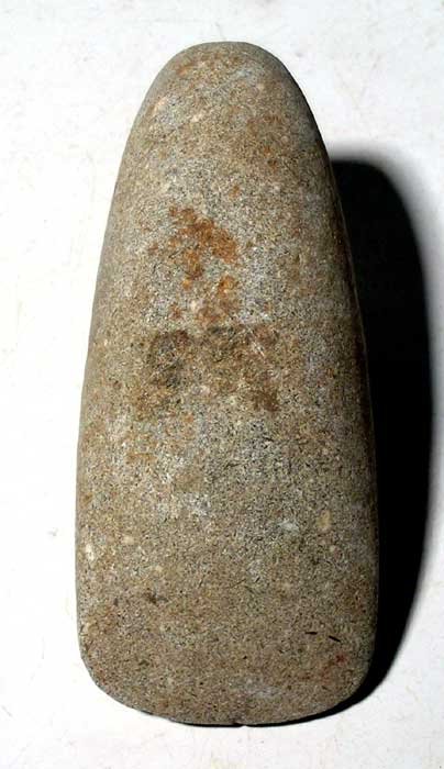 An Egyptian Pre-Dynastic stone axe head: An Egyptian Pre-Dynastic stone axe head, c. 4000 - 3000 BC. It is 3-3/4 in long, 1-5/8 in wide and still has a sharp bit. Made from a speckled blue-grey stone, with a slight indentation on one side an