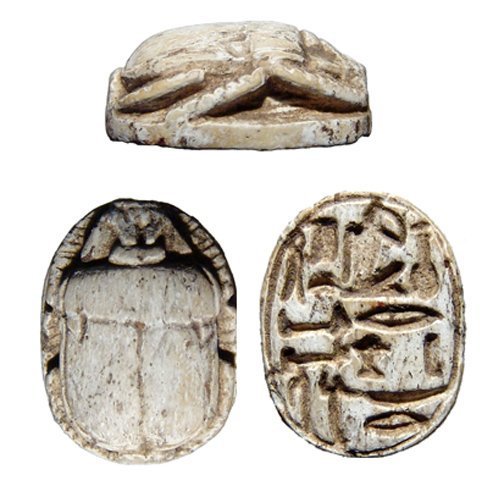 A nicely carved Egyptian steatite scarab: A nicely carved Egyptian steatite scarab, New Kingdom, c. 1570 - 1075 BC, the body well carved and the base with detailed inscription. 18 x 13mm. Intact, no remaining glaze, longitudinal hole for susp