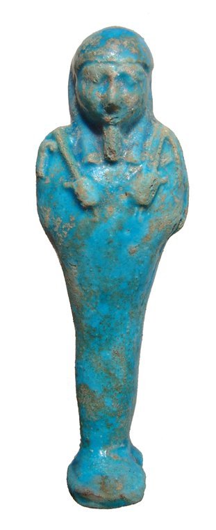 Egyptian blue faience ushabti, Late Period: A choice Egyptian blue faience ushabti, Late Period, c. 664 - 30 BC, mummiform, wearing tripartite wig and false beard. Arms folded across chest, hands holding a pick and hoe, bag over left shoulder.
