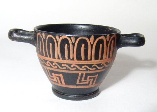 Apulian Xenon-ware skyphos, Magnia Graecia: An Apulian Xenon-ware skyphos, Magnia Graecia, c. 330 - 300 BC, with three bands of applied decoration. H: 2 7/8 in (7.3cm); D: 5 5/8 in (14.3cm). Expert restoration on one side. Ex J.M.E. Collection,
