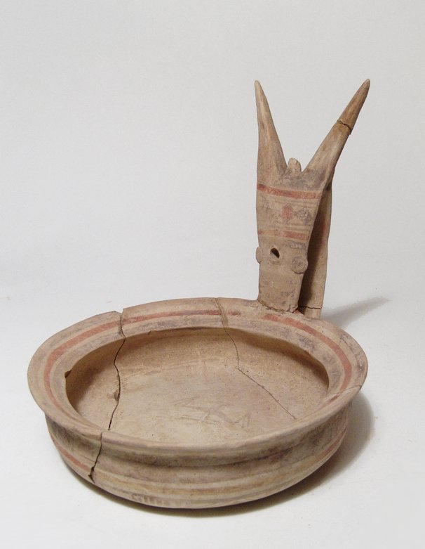 A Daunian Geometric Kyathos: A Daunian Geometric Kyathos, c. 6th - 4th Century BC, or wine ladle, the handle with two long prongs and the bowl wide and shallow with wide, angled rim. The decoration consists of banding and geometr