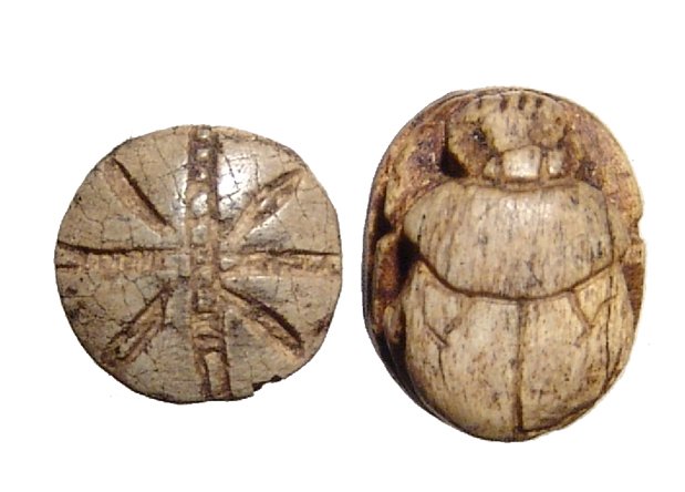 2 Egyptian scarabs, one a button scarab, New Kingdom: A lot of 2 Egyptian scarabs, one a button scarab, New Kingdom, c. 1570 - 1075 BC, the scarab neatly carved with text on base, (1.3 x 1 cm), the scaraboid with rosette on back, the base with a monkey h