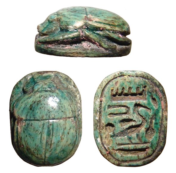 Egyptian steatite scarab, New Kingdom: A nice Egyptian steatite scarab, New Kingdom, c. 1570 - 1075 BC, with attractive blue-green glaze, the body nicely carved and the base with neatly incised hieroglyphic characters. L: 3/5 in (1.6cm). E
