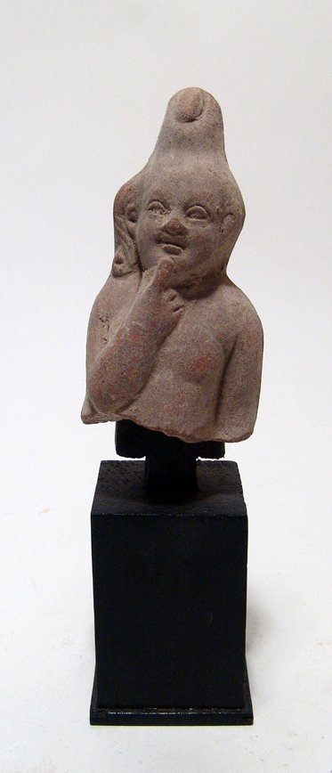 Egyptian terracotta figure of youthful Harpokrates: An Egyptian terracotta figure of youthful Harpokrates, Ptolemaic, c. 3rd - 1st Century BC, with pleasing features and wearing the double crown of Upper and Lower Egypt, right finger to his lip. A very