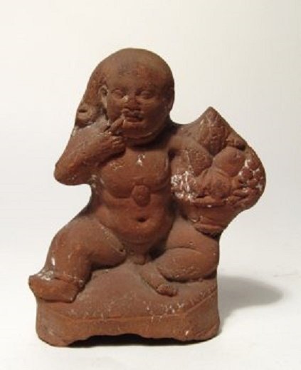 An Egyptian terracotta figure of Harpokrates: An Egyptian terracotta figure of Harpokrates, Roman, 1st - 2nd Century AD, depicted as an nude infant, the young god is seated facing on the ground, wearing a flask around his neck or solar disk penda