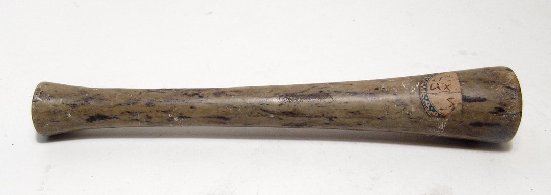 An Egyptian green steatite wand or ritual item: An Egyptian green steatite wand or ritual item, c. 1st Millennium BC, trumpet-shaped with narrow shaft, widening at either end and completely drilled through with narrow hole. Perhaps this is a music 