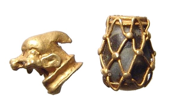 A pair of Egyptian gold jewelry elements: A pair of Egyptian gold jewelry elements, Ptolemaic, c. 4th - 1st Century BC, the first the small head of a bird, the second an oval stone bead with gold netting around it. Lengths: Both .6 cm. Ex Phi
