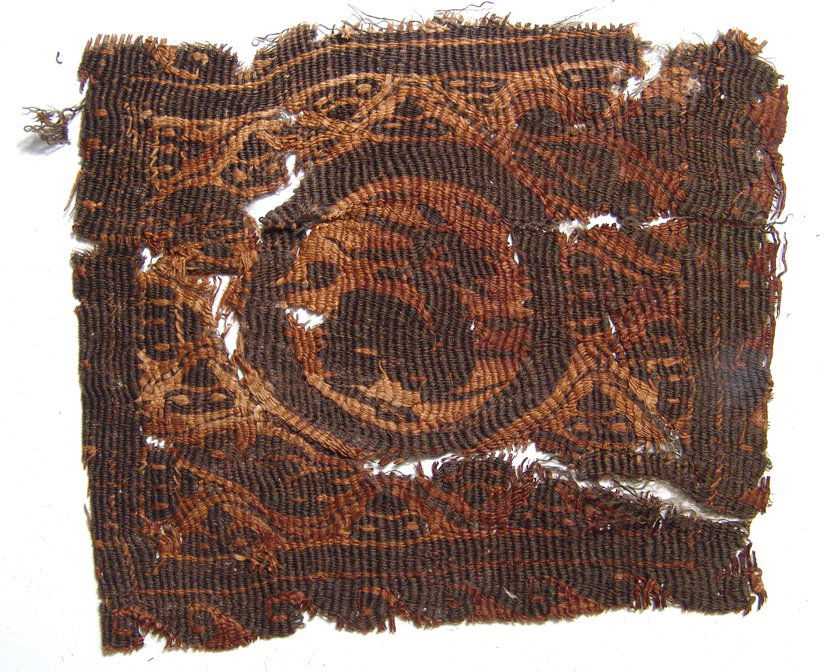 Coptic textile fragment depicting a horned antelope: A nice Coptic textile fragment depicting a horned antelope, early Byzantine, c. 6th - 7th Century AD, the animal within a central ring bordered by stylized floral devices which in turn are bordered by