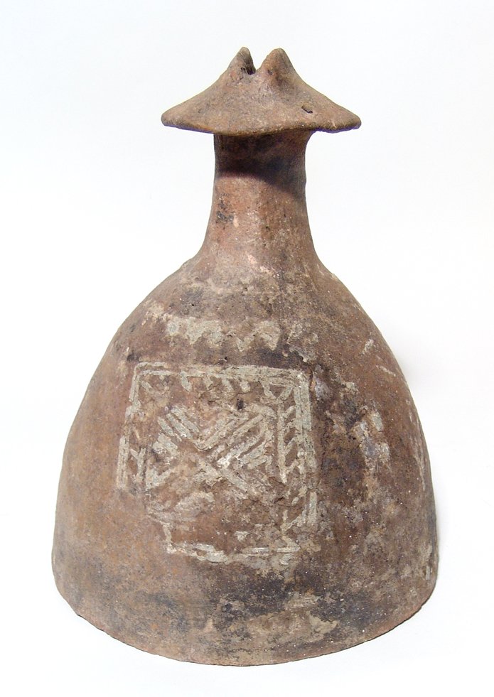 An Etruscan/Villanovan impasto lid from an urn: An Etruscan/Villanovan impasto lid from an urn, c. 8th Century BC, of domed construction narrowing at topped by a circular ‘handle’ surmounted by female genitalia, 7 holes around. The sides of the
