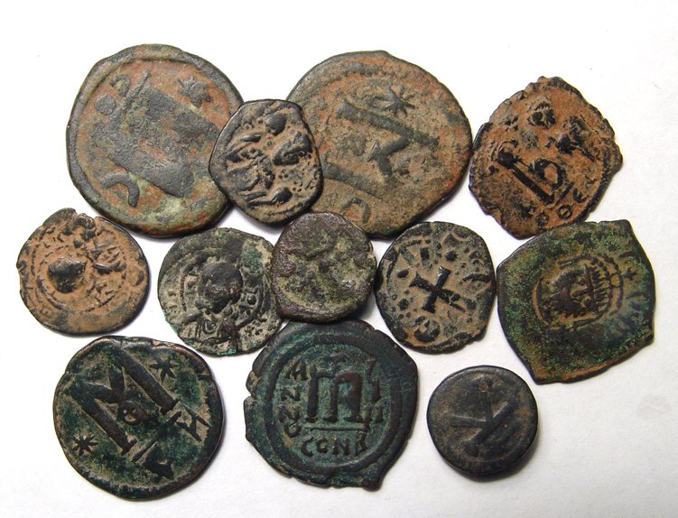 A lot of 12 Byzantine bronze coins: A lot of 12 Byzantine bronze coins. Lot includes examples which span the length of the empire from Justinian I through Alexius I, some with images of Christ. Ex Los Angeles private collection.
