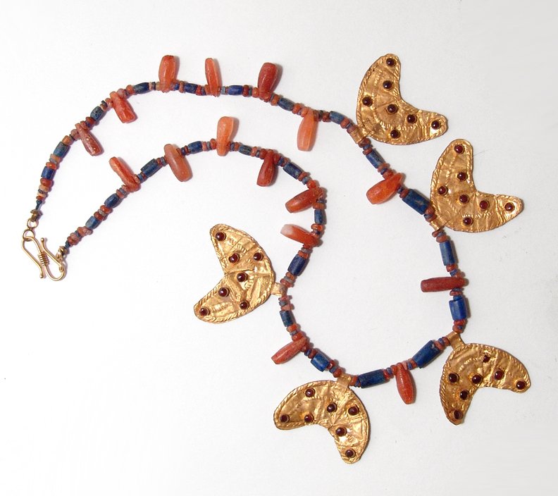Beautiful lapis and carnelian bead necklace: A beautiful lapis and carnelian bead necklace with gold crescents, Eastern Mediterranean, c. 2nd Millennium BC, the stone beads hand-shaped with roughly tubular-shaped lapis beads interspersed with de