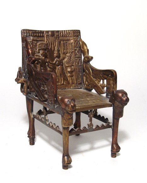 Egyptian Revival throne of Tutankhamen: An Egyptian Revival throne of Tutankhamen, 1920’s, in bronze and brass, preserving much of the detail of the original and attractively toned. 7 in x 4 ¾ in x 5” (17.7 x 12.1 x 12.8 cm). Ex Los An