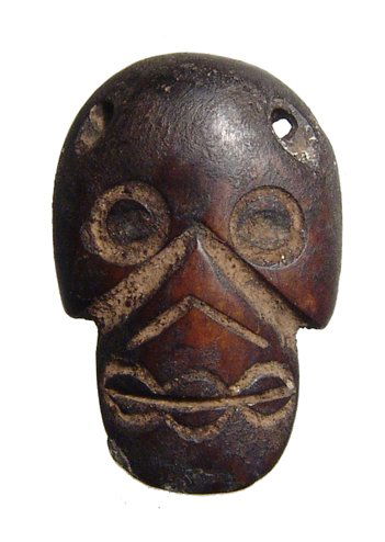 A rare Aztec carved wood pendant of a skull (1 of 2)