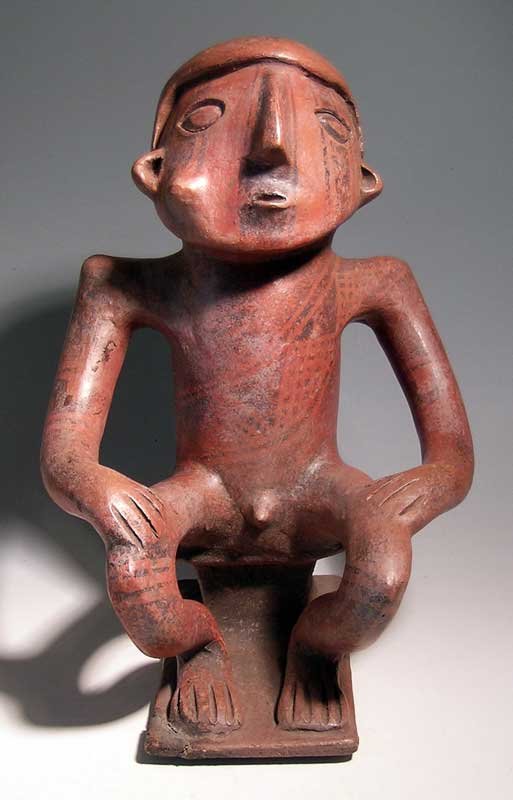 Narino Coquero effigy from Colombia: A large Narino Coquero effigy from Colombia, ca. AD 850 - 1500. It is 12-1/2 in high and depicts a male figure seated on a bench. He is depicted chewing coca leaves, as indicated by the large bulge in